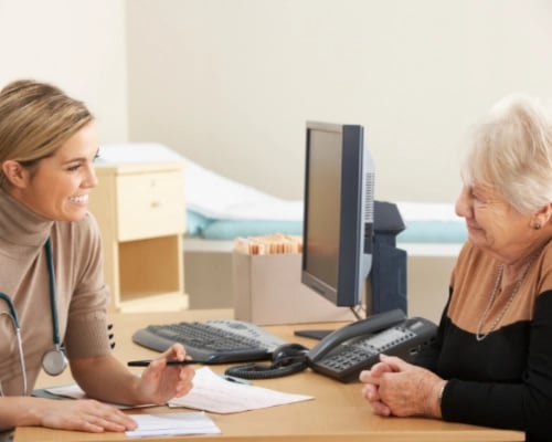 Old woman consulting with a doctor
