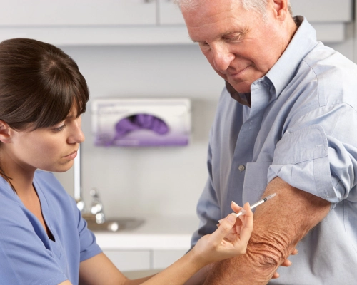 Doctor injecting a vaccine into a patient