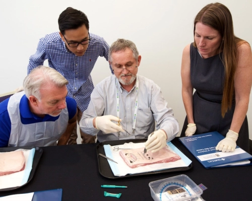 Teacher demonstrating skin cancer medicine procedures