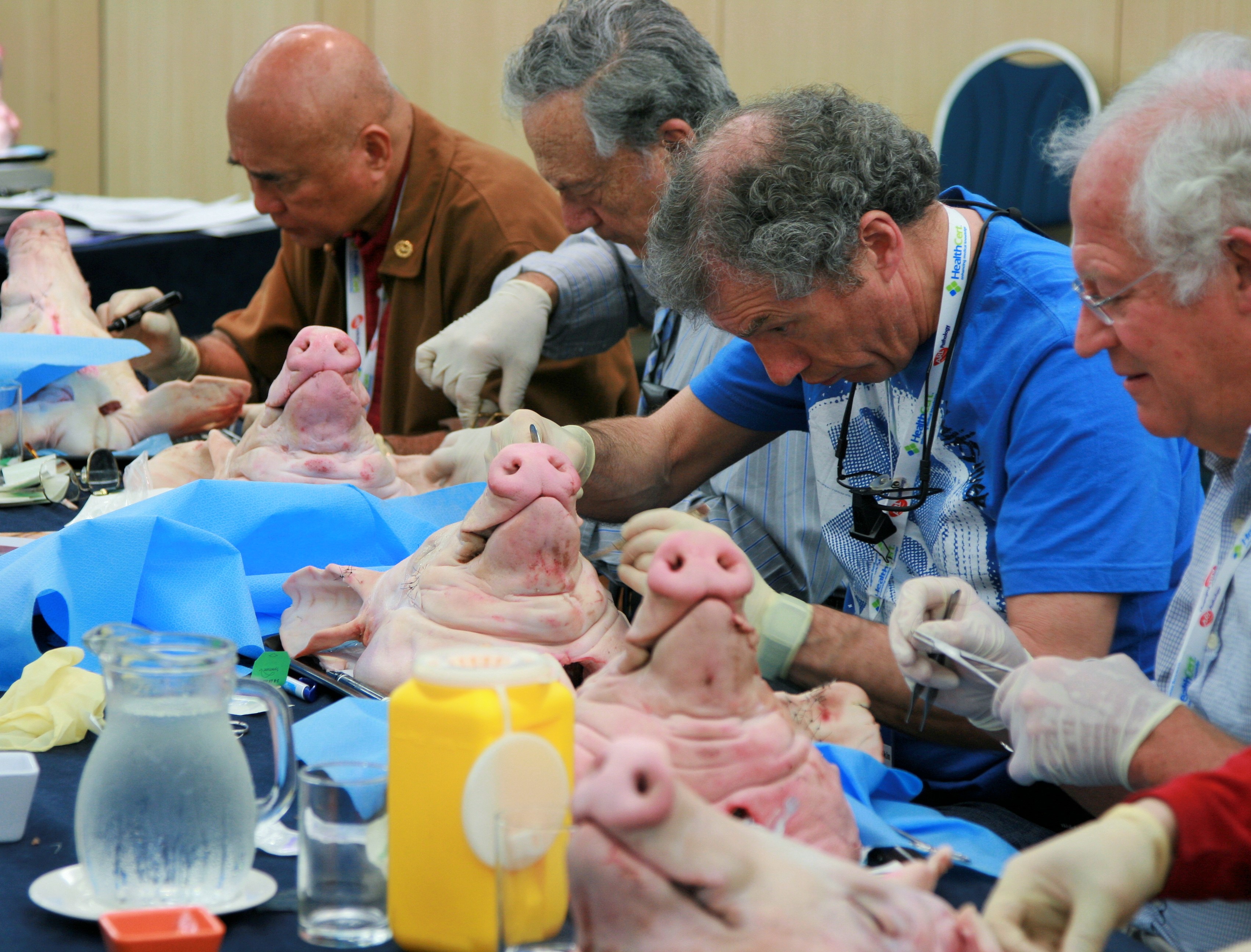 Doctors practising skin cancer surgery techniques at a HealthCert workshop