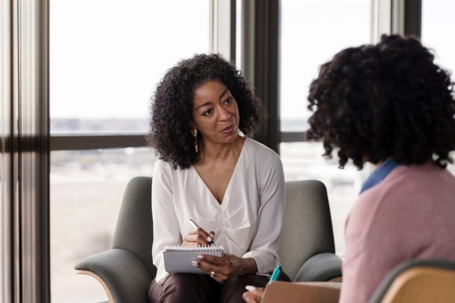 Woman doctor talking to a patient